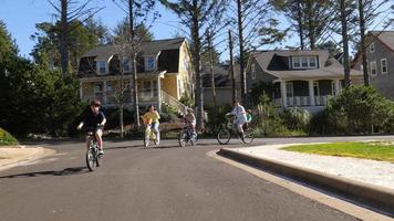 Family riding bikes in coastal community