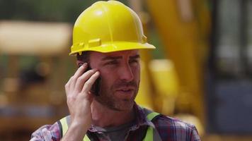 trabajador de la construcción hablando por teléfono celular