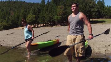 Couple getting ready to kayak at lake video