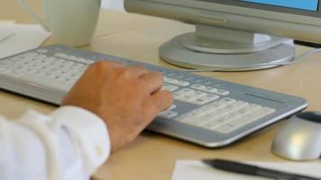 Timelapse shot of businessman typing on keyboard at office desk video