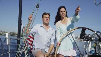 Young couple on sailboat together. video