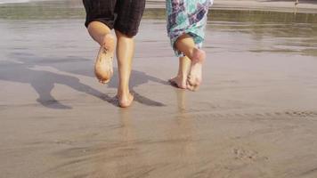 par springer på stranden, närbild av fötter, slowmotion.
