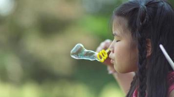 Girl in fairy princess costume blowing bubbles