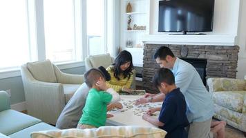 Family playing games together at beach house video