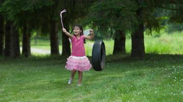 niña en traje de princesa de hadas en columpio de neumáticos, filmada en phantom flex 4k video