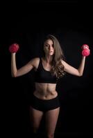 Young beautiful woman making physical exercises with dumbbells. photo