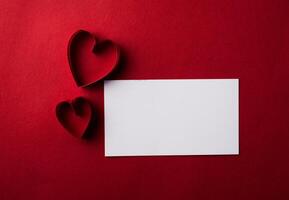 Red Heart paper and blank with note card on Red background. photo