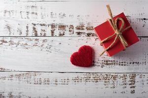 Gift box on wood background, valentine's day concept. photo