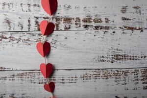 Top view Red heart in line on wood background. photo