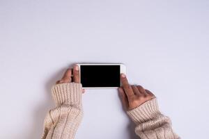 top view hand holding cell phone on white background. photo