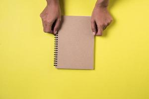 Woman's hands with blank notebook.