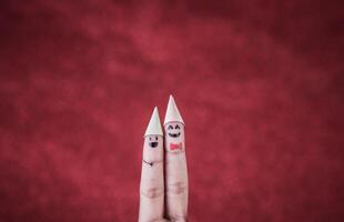 Finger with emotion on red background. photo