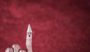 Finger with emotion on red background. photo