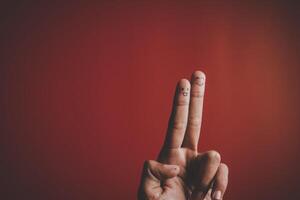 Finger with emotion on red background. photo