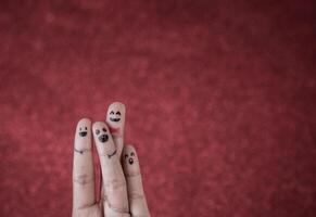 Finger with emotion on red background. photo