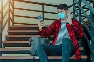 Asian man making facetime video calling with smartphone at home photo