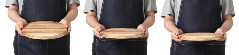 Chef holding wooden cuttingboard on white background photo