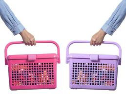 Hand holding plastic basket on white background photo