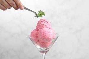 Food stylist use tweezers decorating fake icecream photo