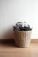 Wooden basket with dirty laundry photo