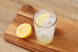 Cold lemonade in glass on tray photo