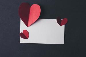 Heart and blank with note card on Red background. photo