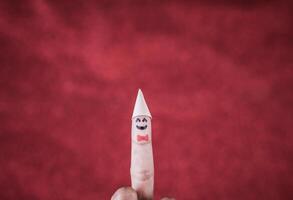 Finger with emotion on red background. photo