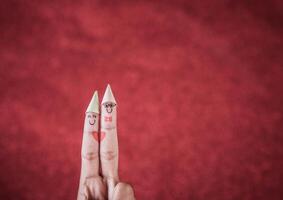 Finger with emotion on red background. photo