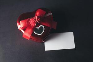 Heart shaped gift box with blank note card, Valentines day. photo