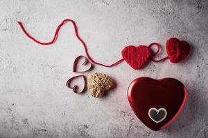 Red yarn heart shaped on the wall background. photo