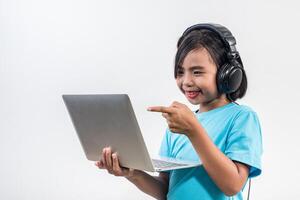 Little girl using laptop computer and listening lesson online. photo