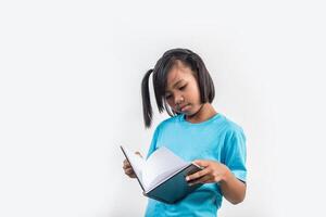 Little girl reading book in studio shot. photo