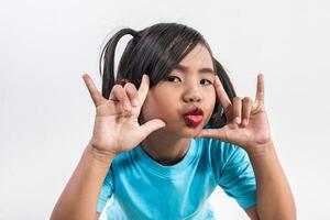 Portrait of Funny little girl acting in studio shot. photo