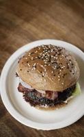 Australian organic beef burger with bacon on wood table background