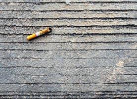 The cigarette butt let down on the concrete floor photo