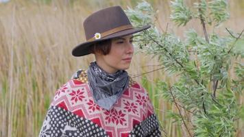 A Young Woman Traveler in Poncho and Hat video