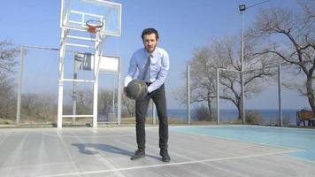 Business Man in Suit and Tie Dribbles a Basketball video