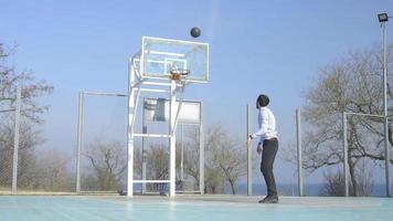 Young Business Man in Suit and Tie Plays Basketball