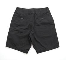Black shorts pants folded isolated on white background photo