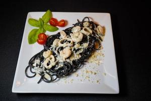 Spaghetti Rigate - black pasta with mixed seafood photo