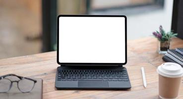 Close-up view of open blank screen laptop computer with office photo