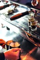 Making espresso coffee close up detail with modern cafe machine photo