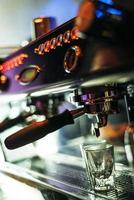 Making espresso coffee close up detail with modern cafe machine photo