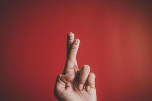 Finger with emotion on red background. photo