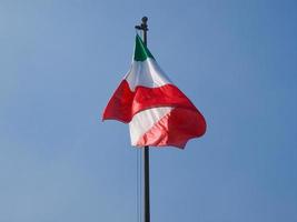 Italian flag over blue sky photo