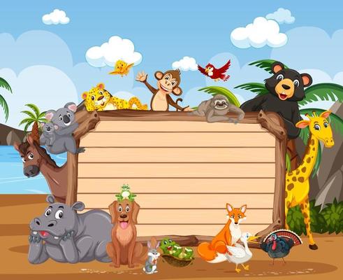 Empty wooden board with various wild animals in the forest