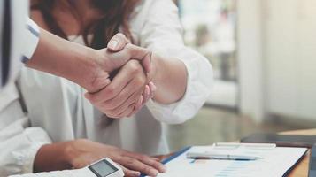 Close up of Business people shaking hands, finishing up meeting photo