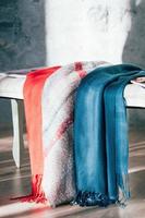 Colorful textile scarves displayed for sale photo