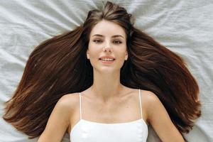 Portrait of attractive caucasian young woman laying down with her hair