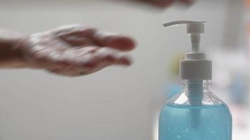 mulher usando gel desinfetante para as mãos para evitar a propagação do vírus.